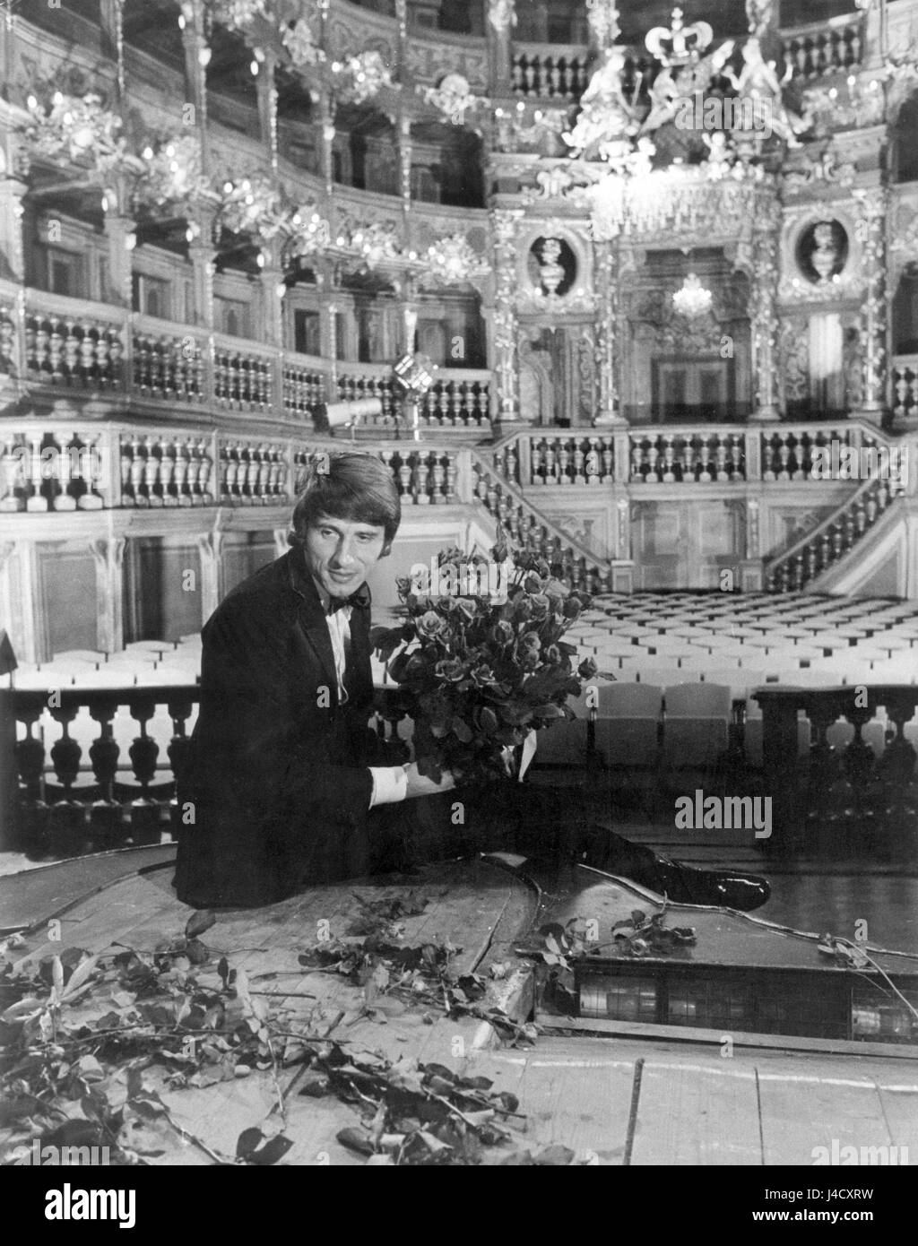 Austrian singer Udo Juergens sits on a prompt box with piles of flowers at the opera house in Bayreuth (Bavaria, Germany) on 3 Septemer 1969.  | usage worldwide Stock Photo