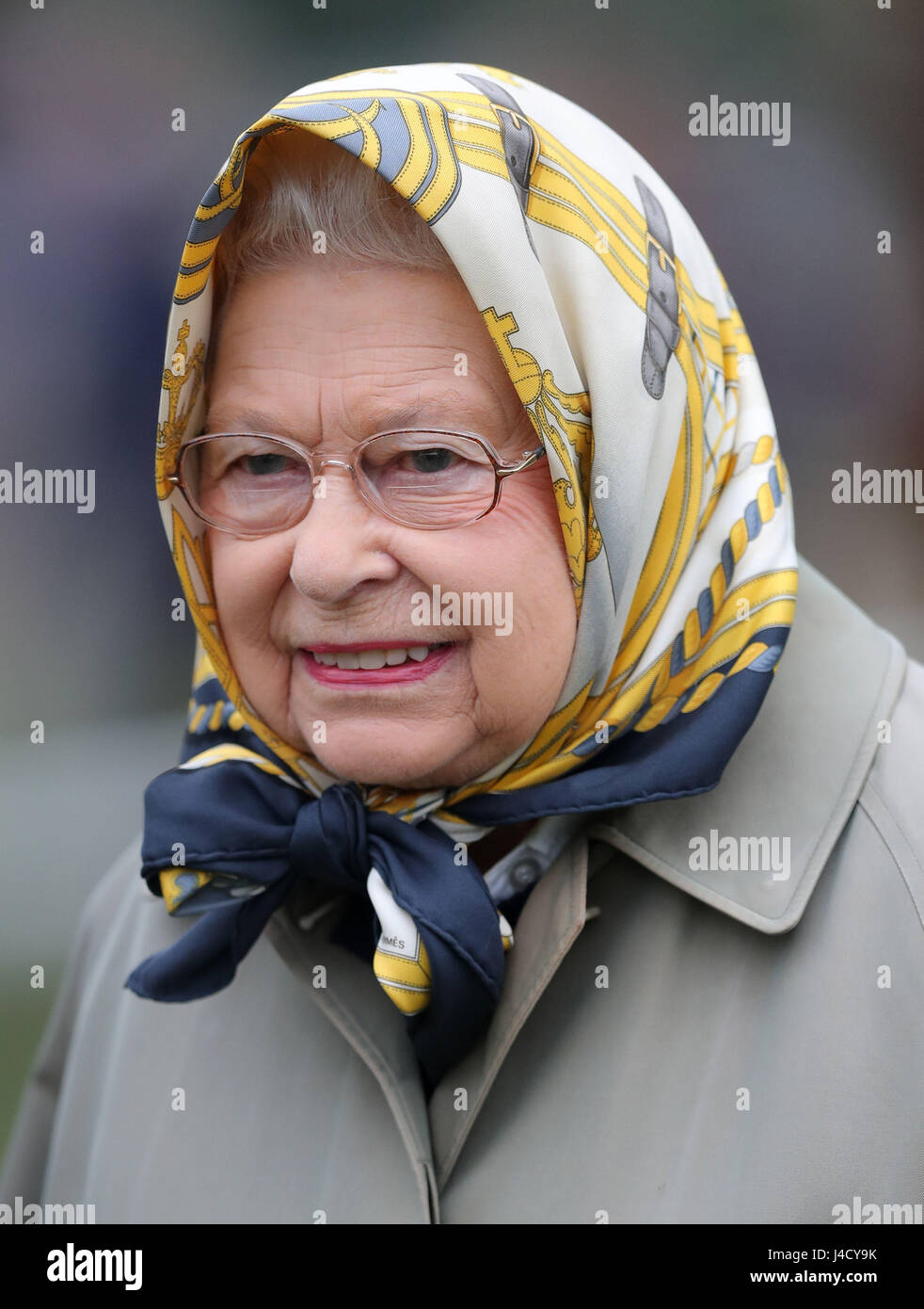 Queen Elizabeth II is presented with a trophy, after her horse Barber's