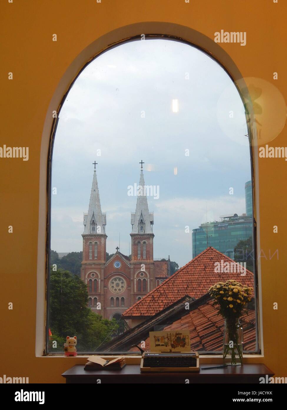 The Cathedral Notre Dame (Nha Tho Duc Ba) in District 1 in Ho Chi Minh City - Saigon seen througt the window of an hip Shopping and Gallery Mall | usage worldwide Stock Photo
