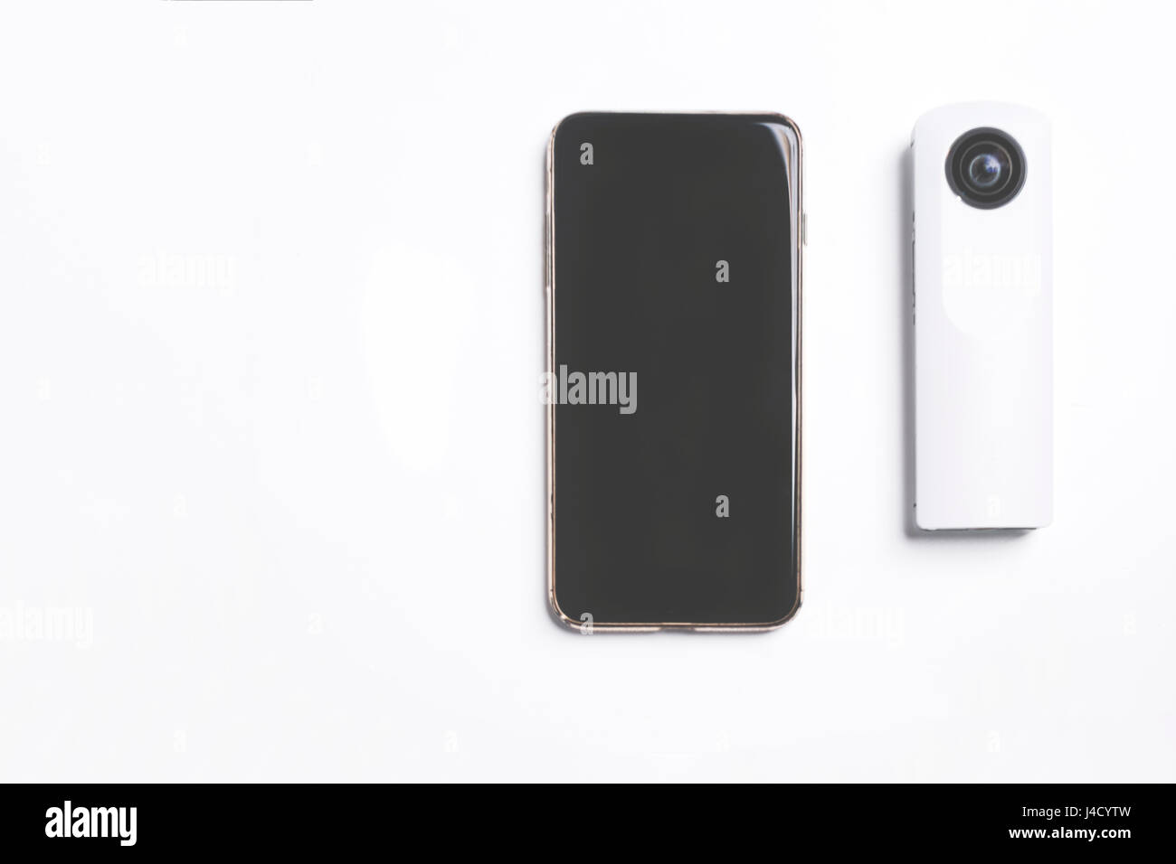 black smart phone and white pano 360 camera on white background : travel essential for shooting connection and sharing Stock Photo