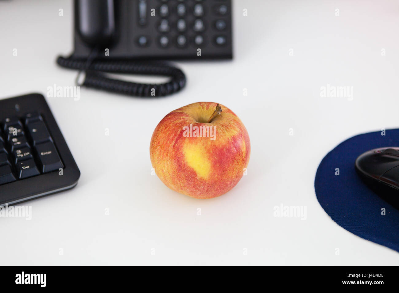 Healthy eating at work, apple on desk Stock Photo Alamy