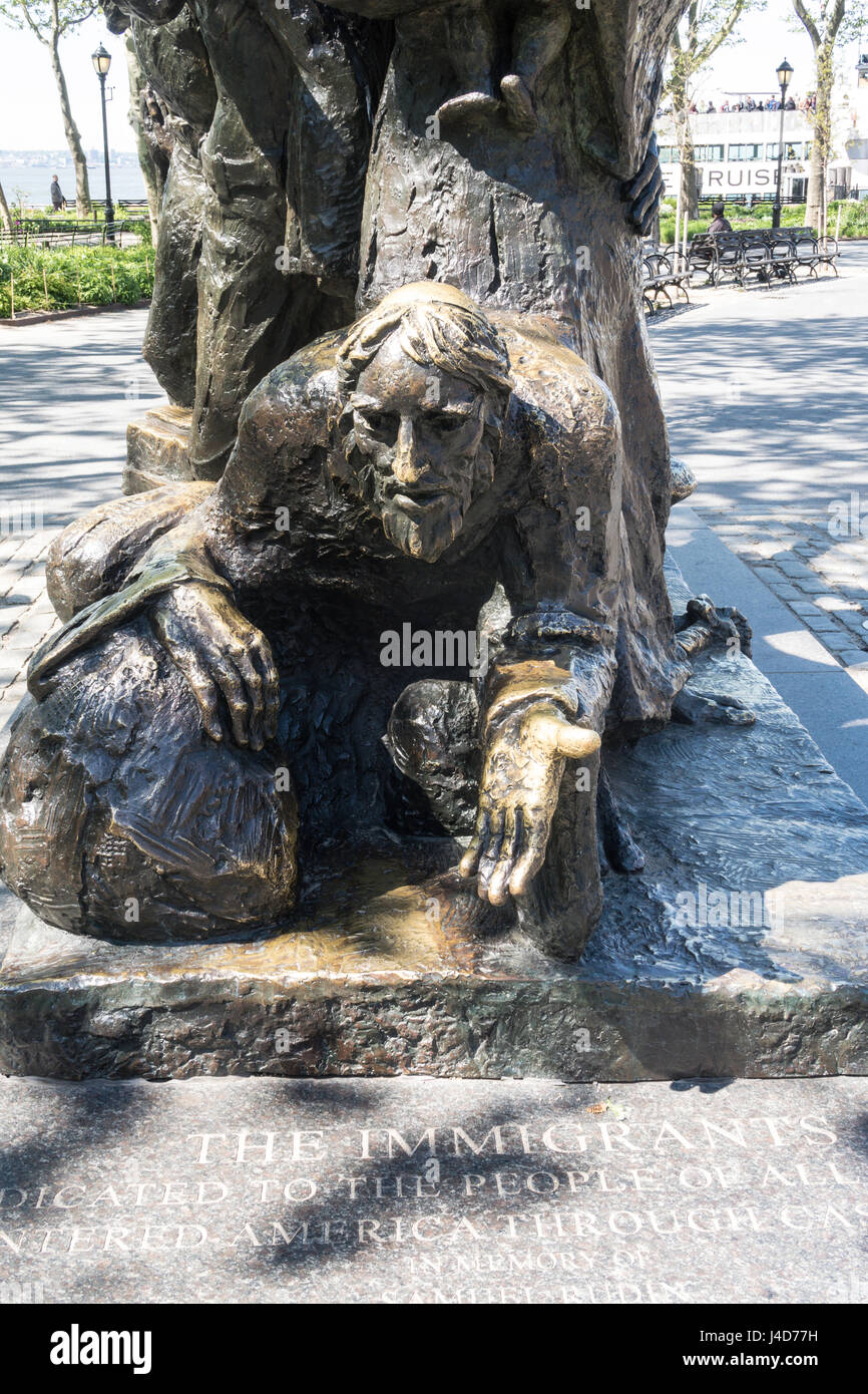 The Immigrants Statue in Battery Park, New York City, USA Stock Photo