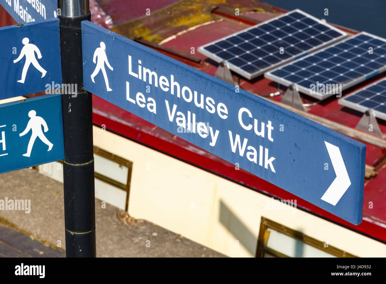 Limehouse Cut and Lea Valley Walk street sign in London with a narrowboat in the backgroun Stock Photo