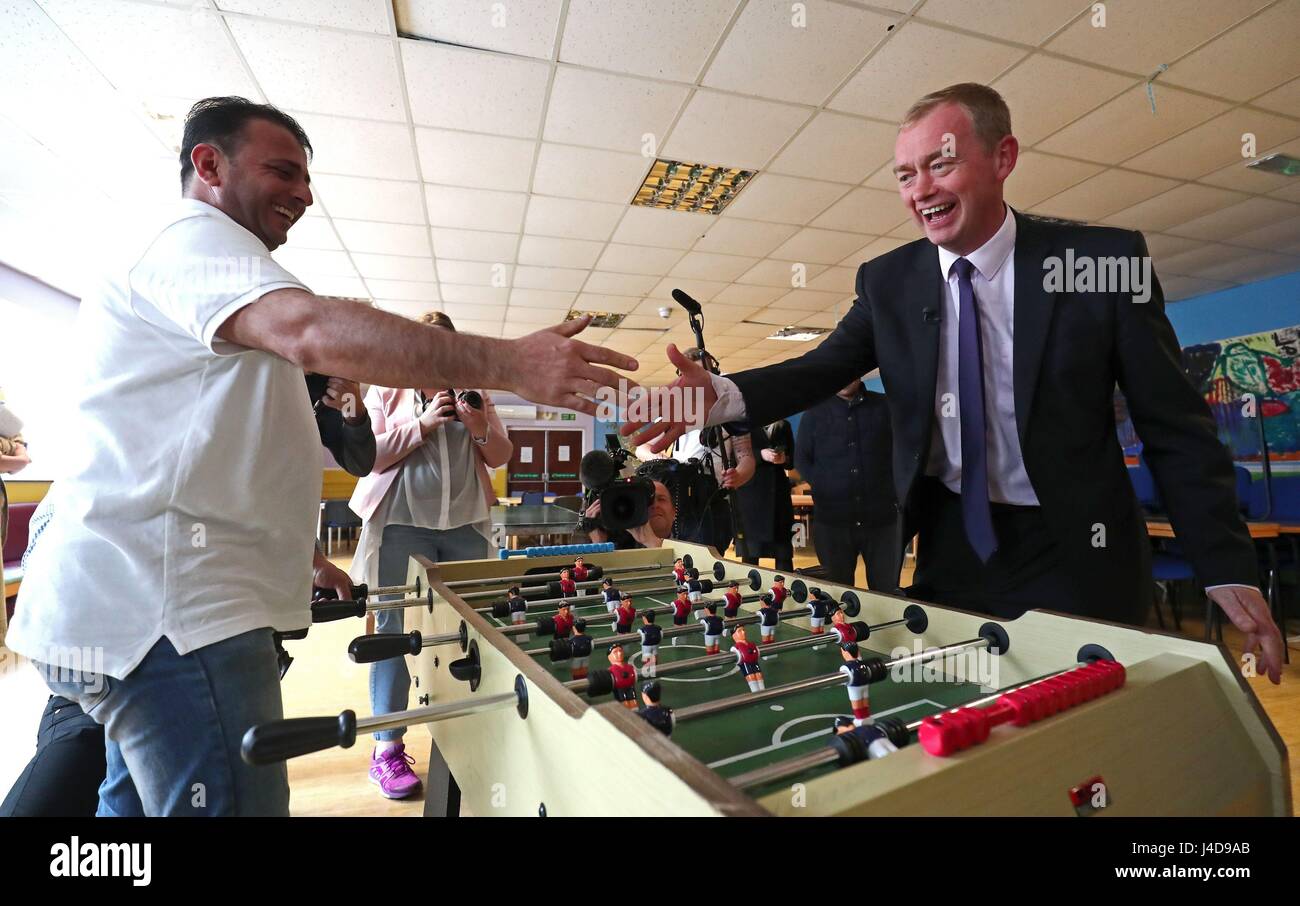 Liberal Democrats leader Tim Farron plays a game on table football during a visit to charity Gloustershire Action for Refugess and Asylum Seekers in Gloucester. Stock Photo