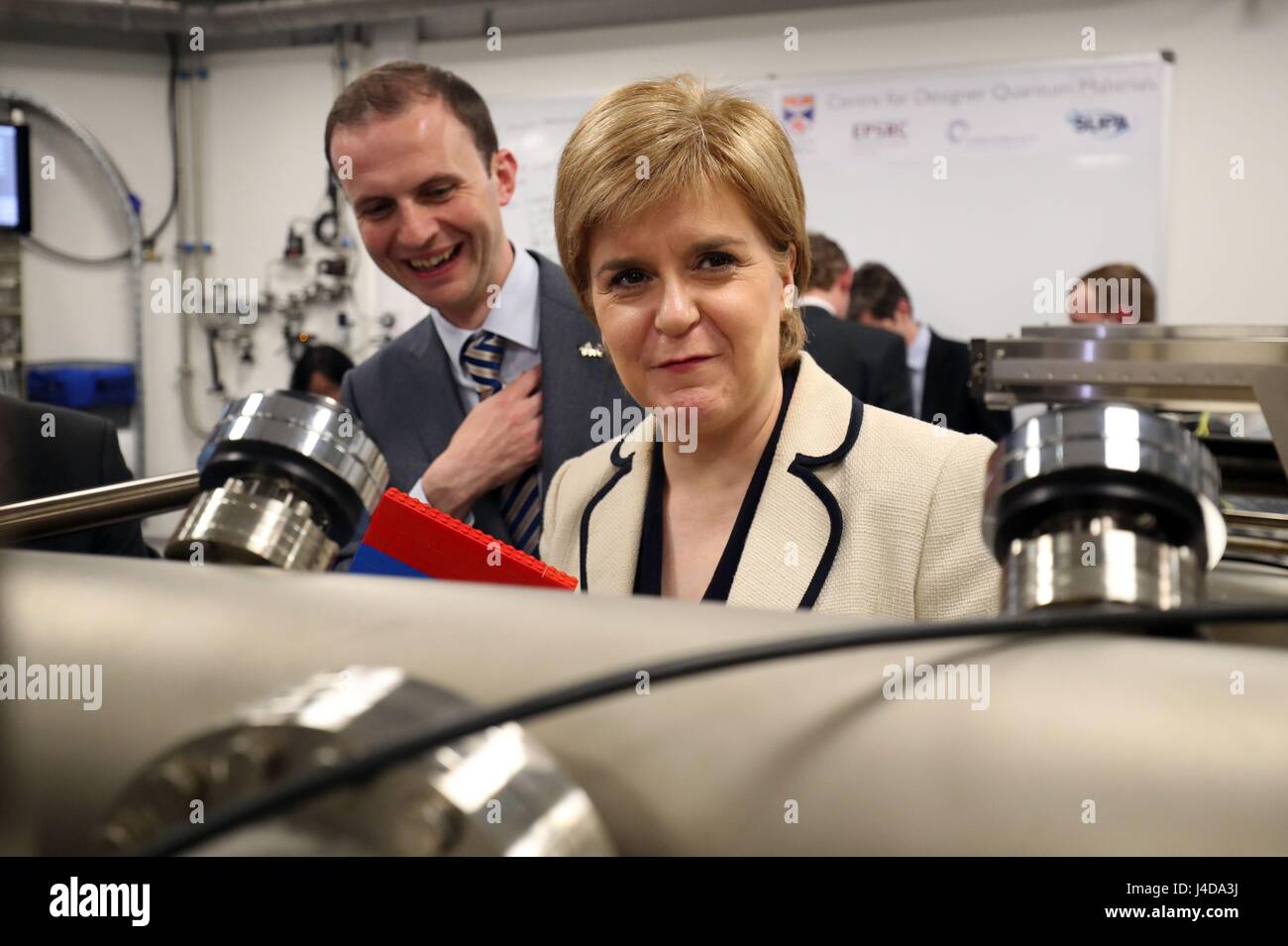 SNP leader Nicola Sturgeon, with North East Fife candidate Stephen Gethins (left), take a closer look at a Molecular Beam epitaxy machine in the Centre for Designer Quantum Materials on the campaign trail at St Andrews University in north east Fife. Stock Photo