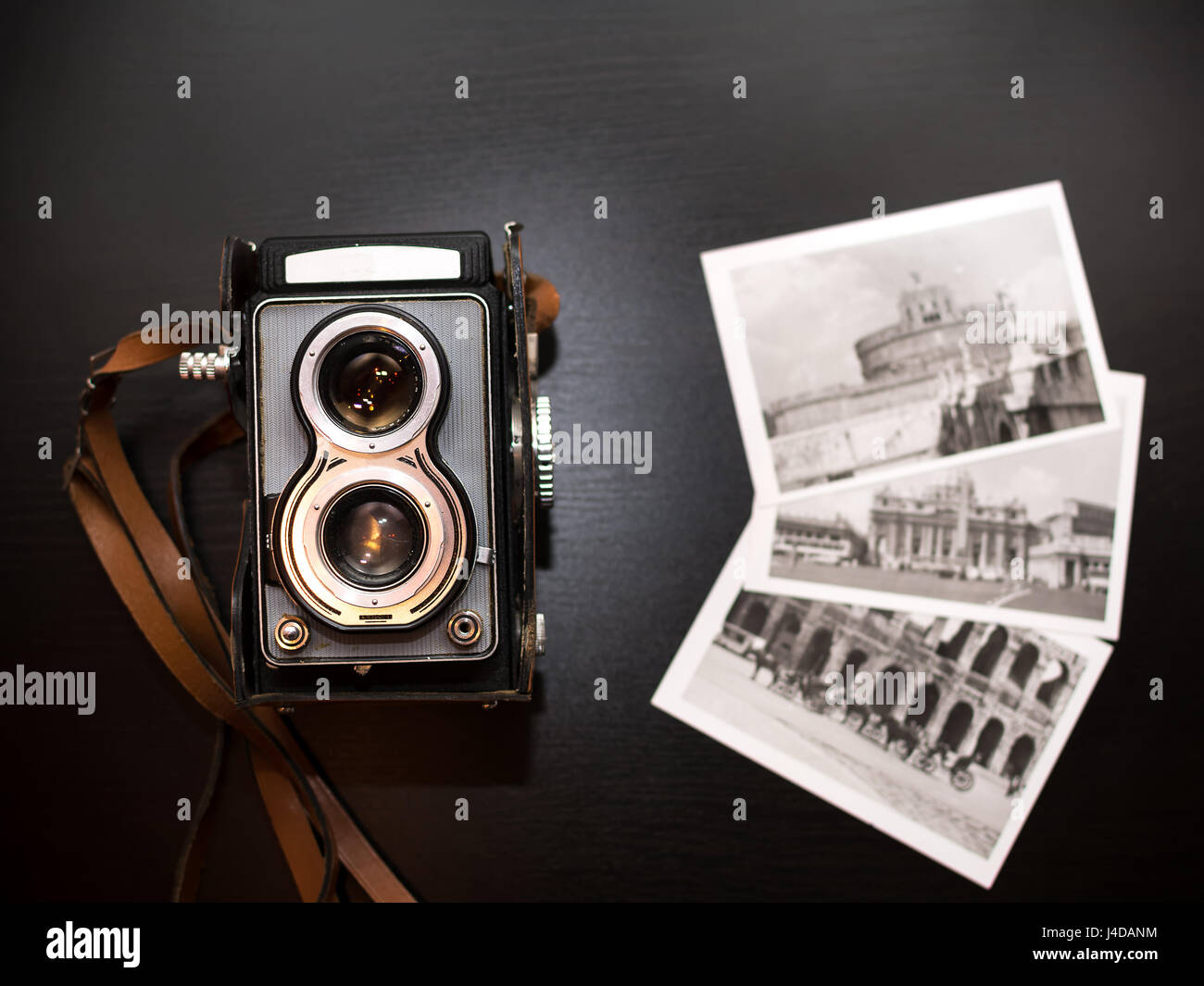 Old biooptic camera and old black and white pics Stock Photo