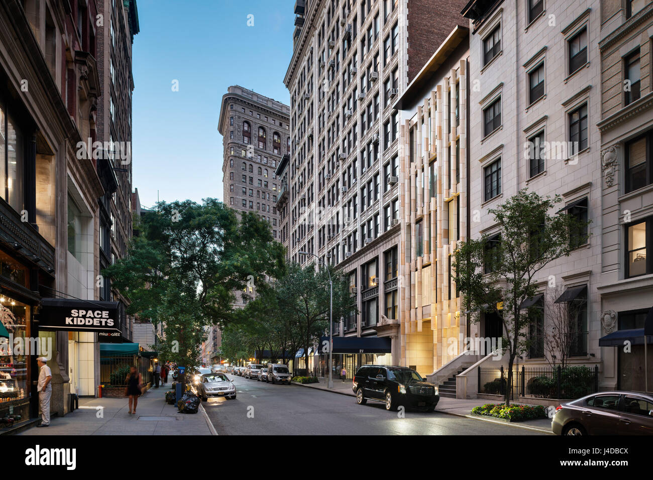 Contextual street view looking West on East 22nd Street at dusk. Gatehouse to One Madison, New York, United States. Architect: BKSK Architects, 2014. Stock Photo