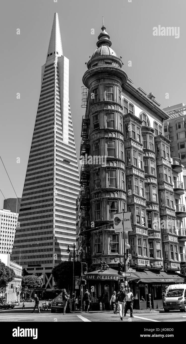 Black and white downtown North Beach San Francisco Columbus Tower Sentinel Tower + Transamerica Bldg, people crossing street in front of Cafe Zoetrope Stock Photo