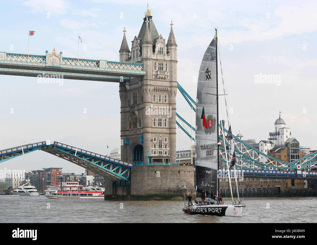 Solo sailor, Ricardo Diniz sails the Taylor325 yacht through Tower Bridge, which has been lifted especially, as he recreates the first shipment of Taylor's Port to London in celebration of the brands 325th anniversary. Stock Photo