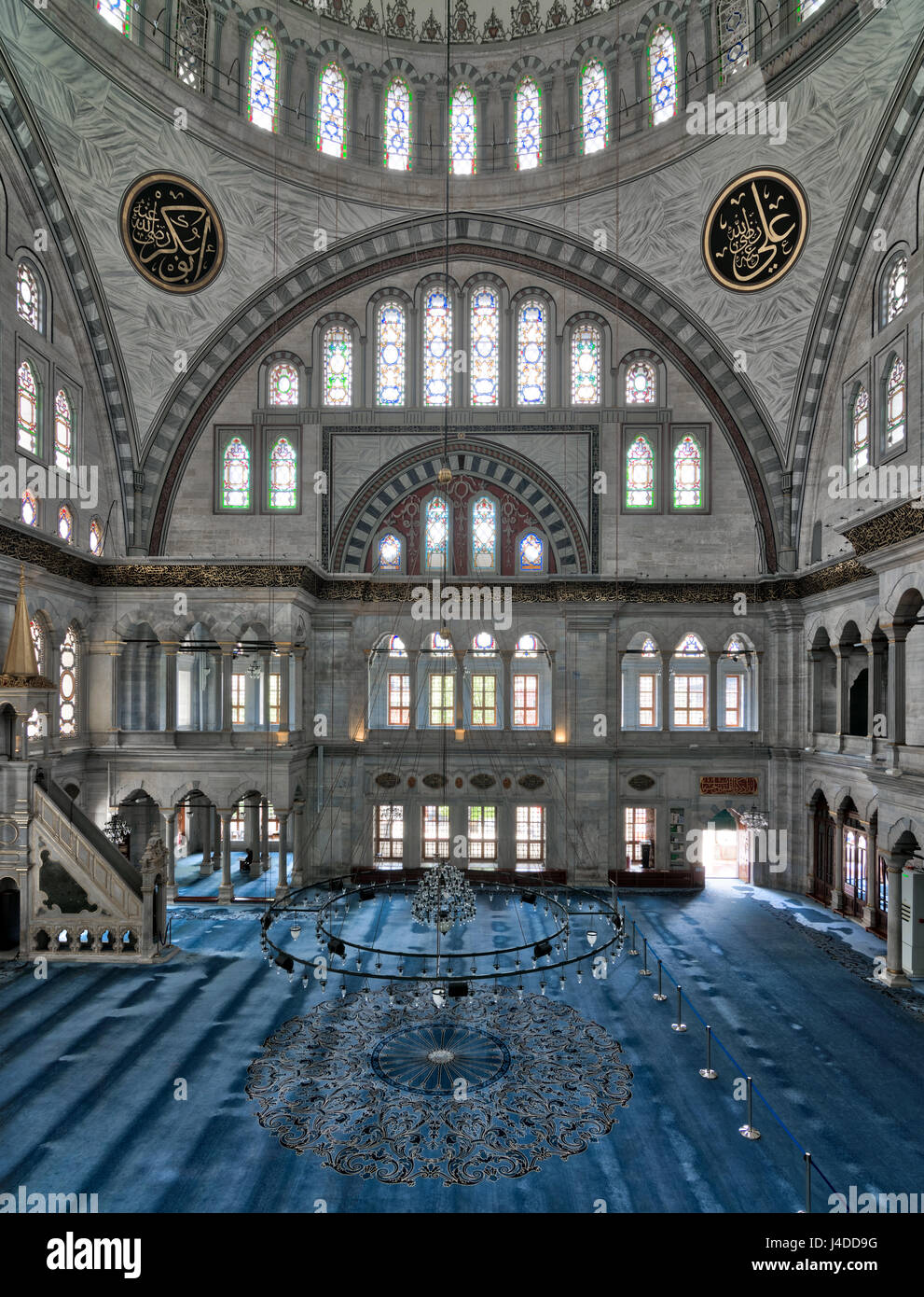 Interior of Nuruosmaniye Mosque, an Ottoman Baroque style mosque completed in 1755, with a huge dome & many colored stained glass windows located in S Stock Photo