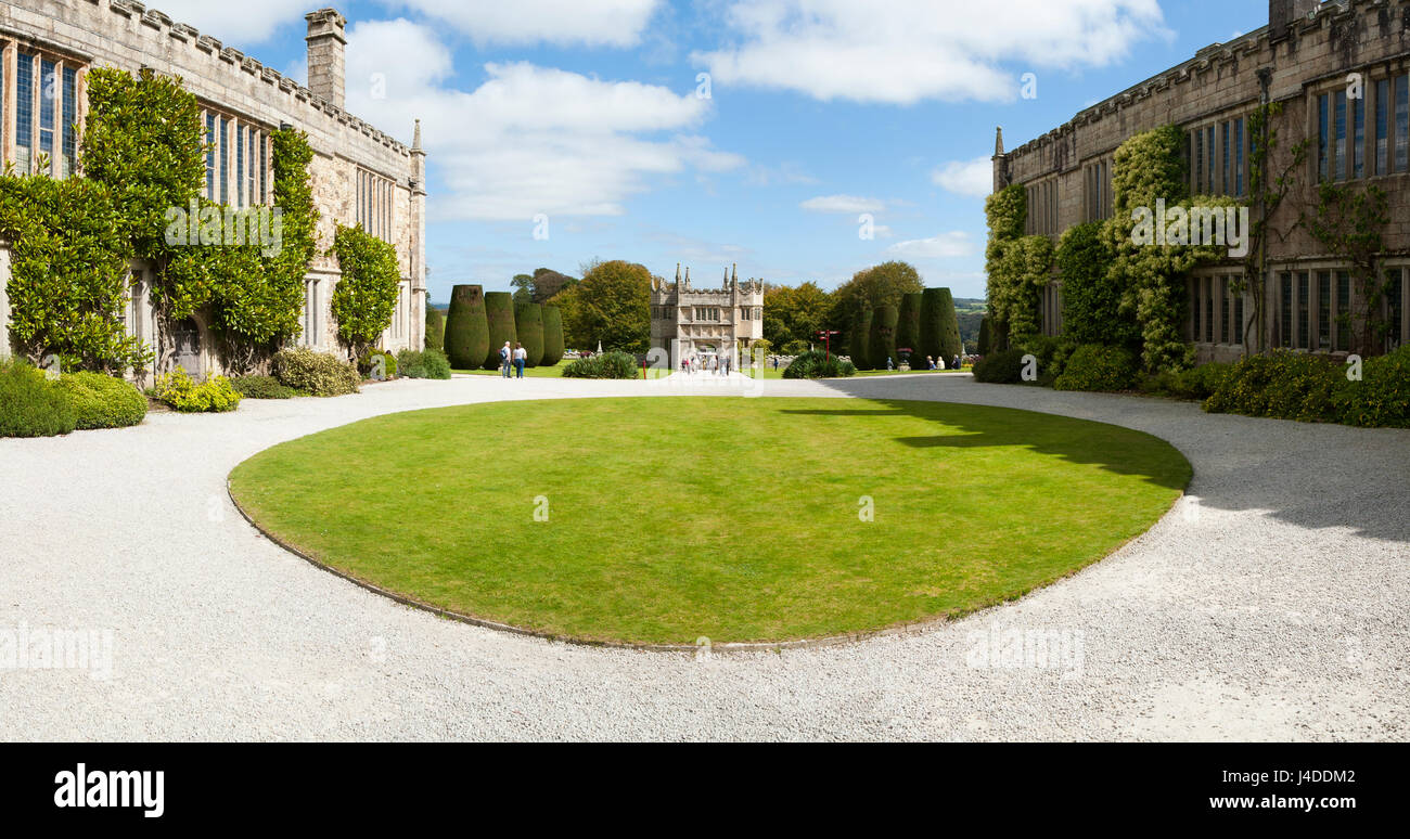 The Circular round lawn grass in front of the main entrance door in the garden / Gardens at Lanhydrock, Bodmin, Cornwall. Gatehouse in distance. Stock Photo