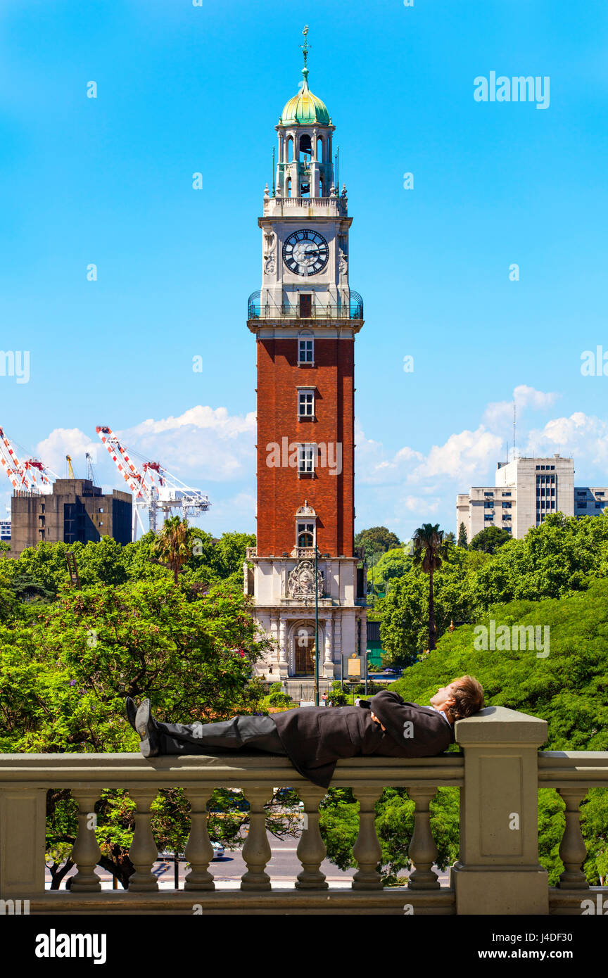 A man in suit relaxing in Plaza San Martin with the Tower of the English in the background. Retiro, Buenos Aires, Argentina. Stock Photo