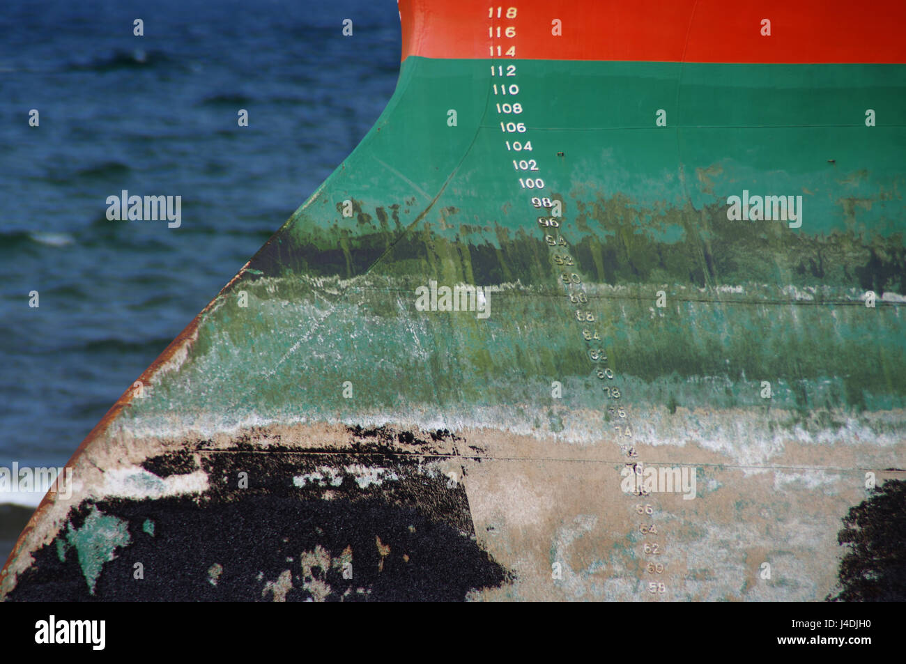 Orange and green ship hull with waterline scale measure Stock Photo