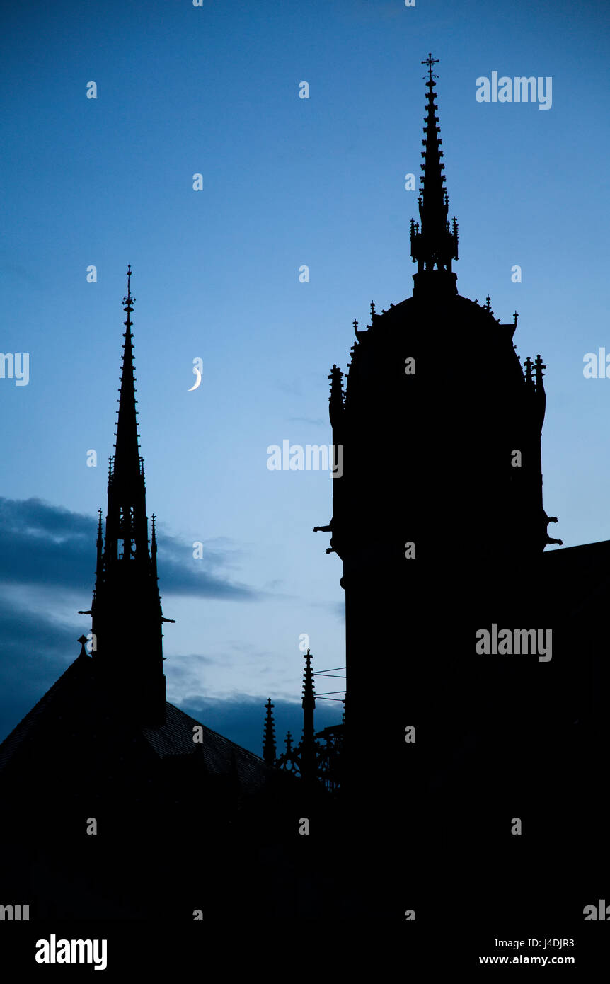 All Saints' church in Lutherstadt Wittenberg, Germany at night with crescent moon Stock Photo