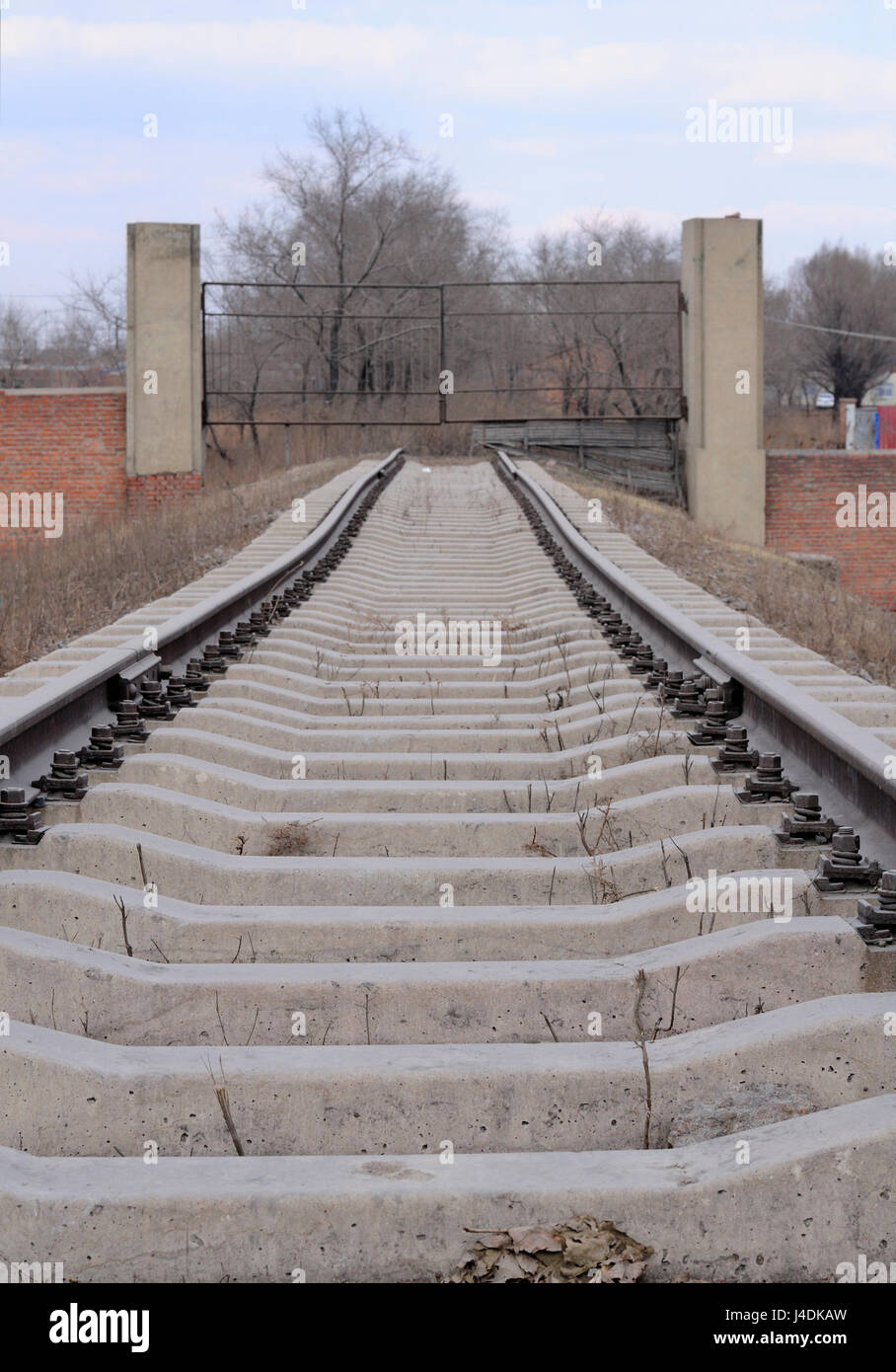 Railroad tracks leading to a metal gate in the city of Zhaodong China