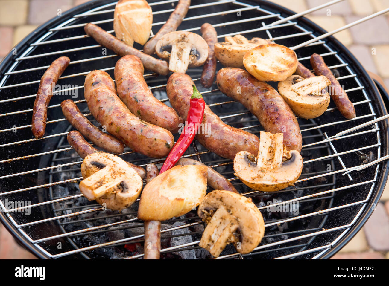 sausages with mushrooms and peppers Stock Photo Alamy