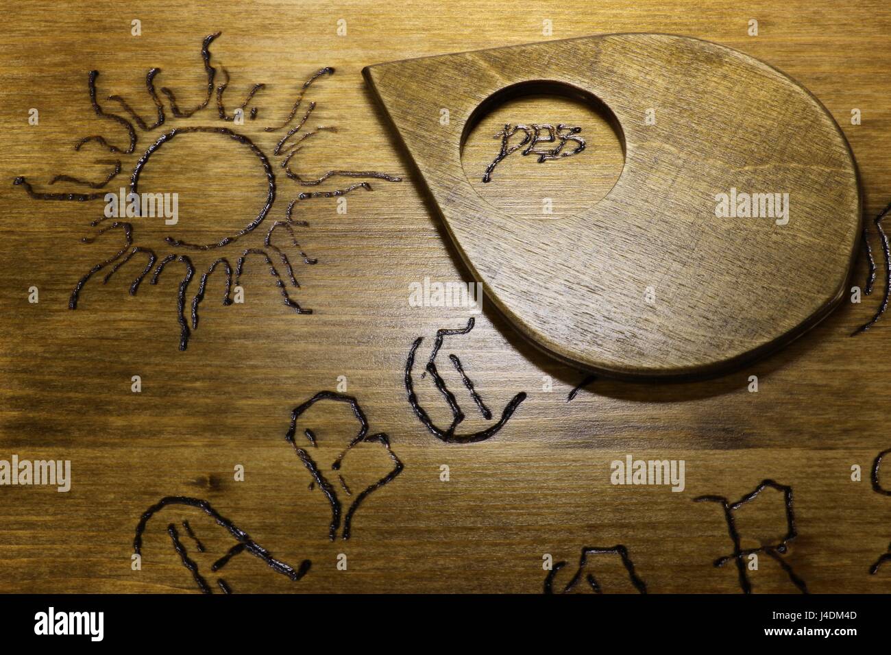 planchette on wooden talking board Stock Photo