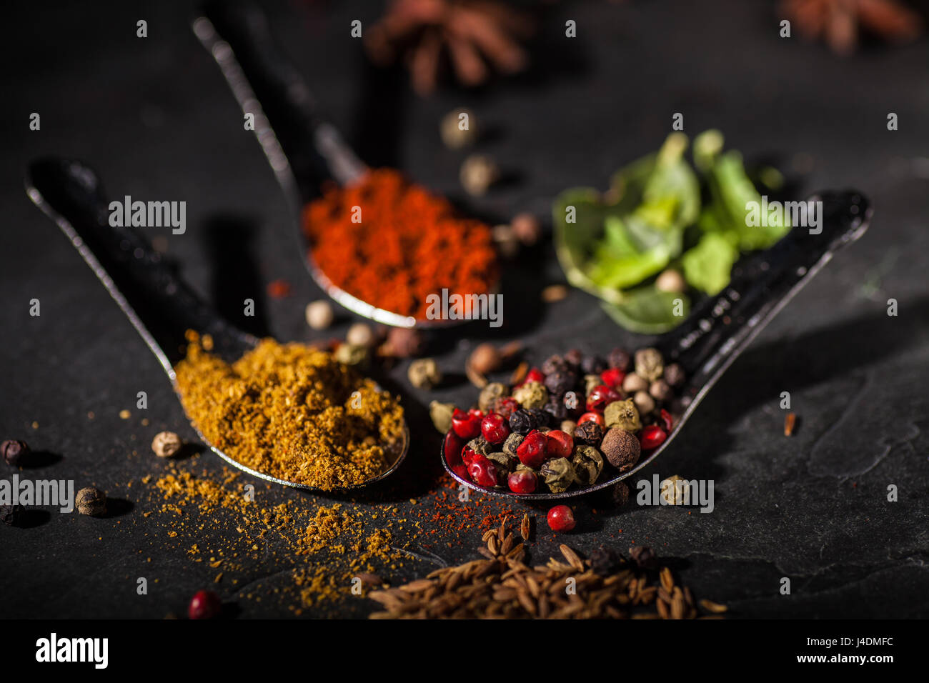 Spice selection on grey slate worktop Stock Photo