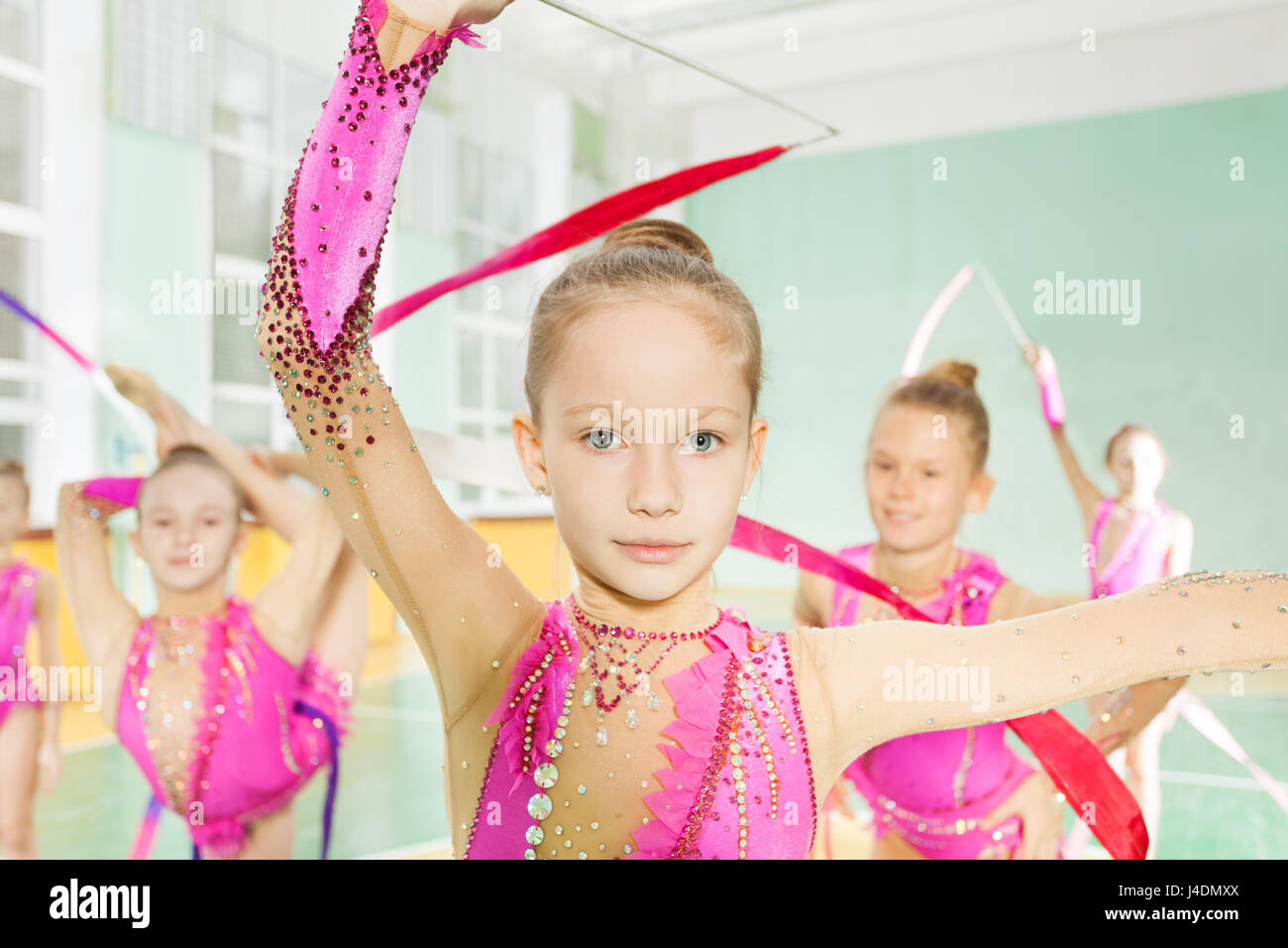 Little girl perform gymnast exercise in group  Stock Photo