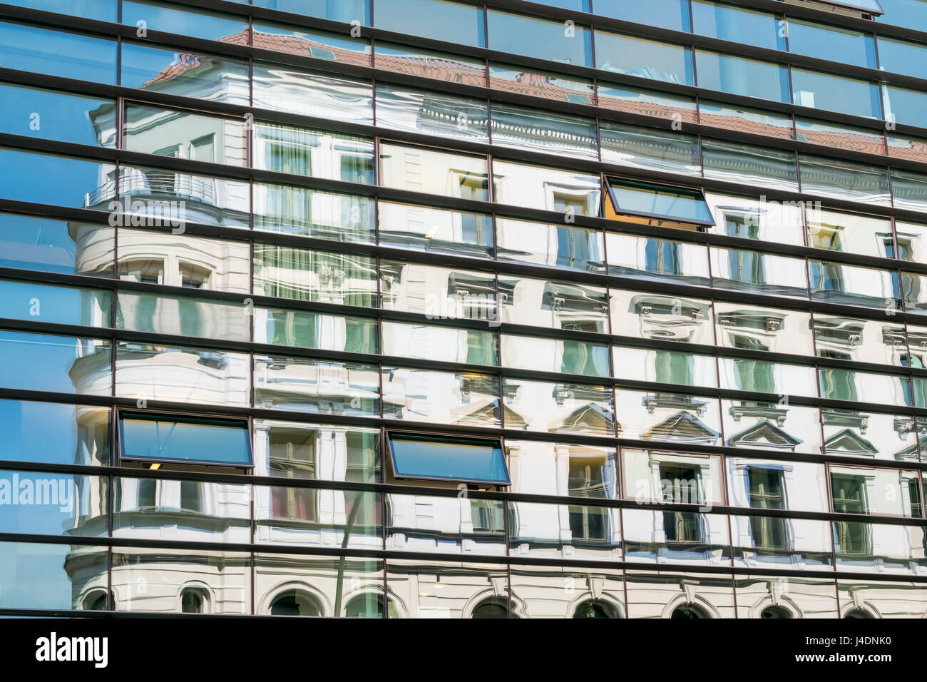 reflection of old building in modern glass facade Stock Photo