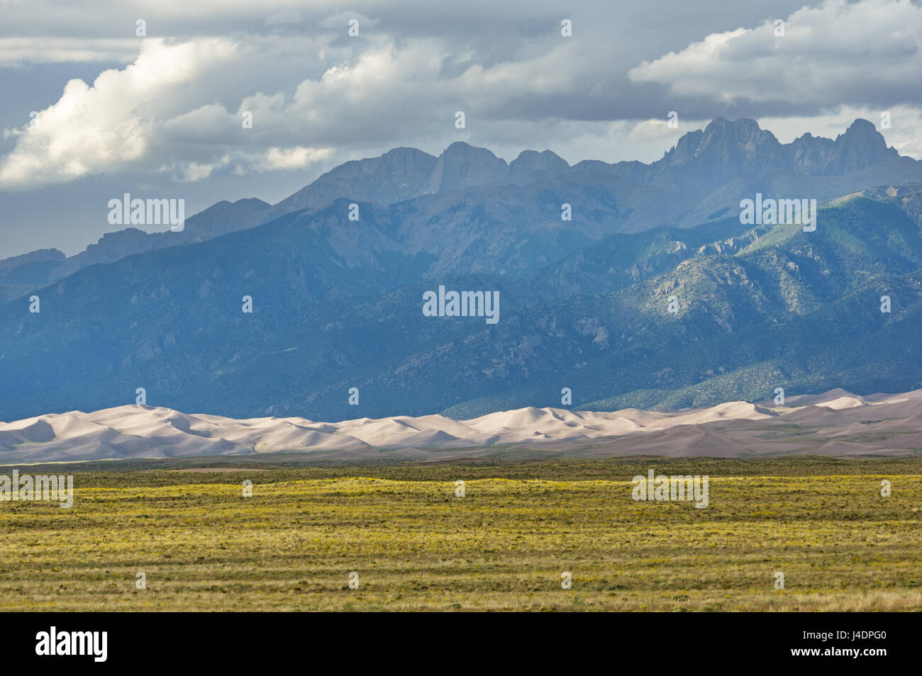The Sangre De Cristo Mountains rise over Great Sand Dunes National Park in Colorado Stock Photo