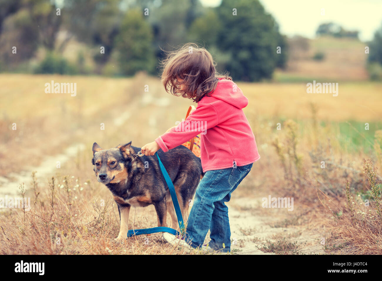 Girl holding dog leash hires stock photography and images Alamy