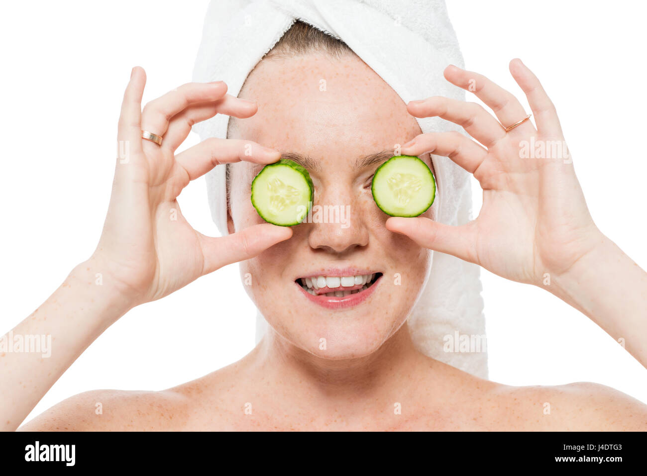 Female portrait with slices of fresh cucumber near eyes closeup on