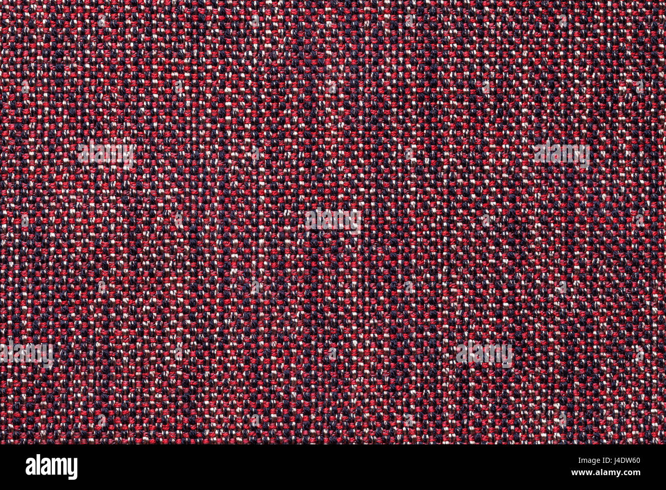 Dark red background with checkered pattern, closeup. Structure of the ...