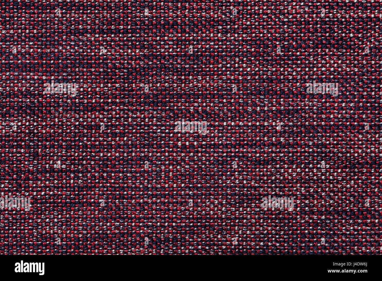 Dark red background with checkered pattern, closeup. Structure of the ...