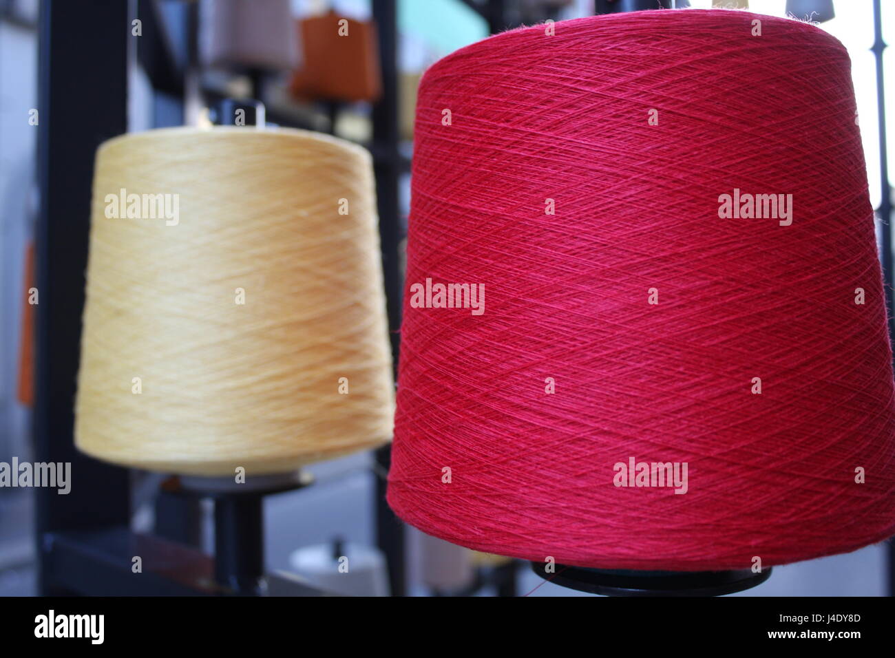 Reels or spools of multicolored sewing threads. Threads of all colors. Stock Photo