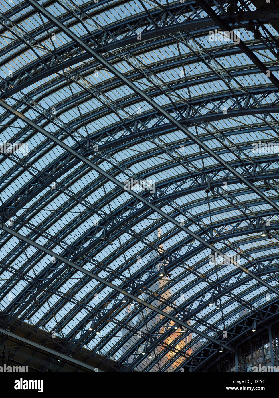 St Pancras Station, London. Trainshed, by William Barlow for Midland Railway in the 1860s. With  Gothic clock tower of the Midland Grand Hotel. Stock Photo