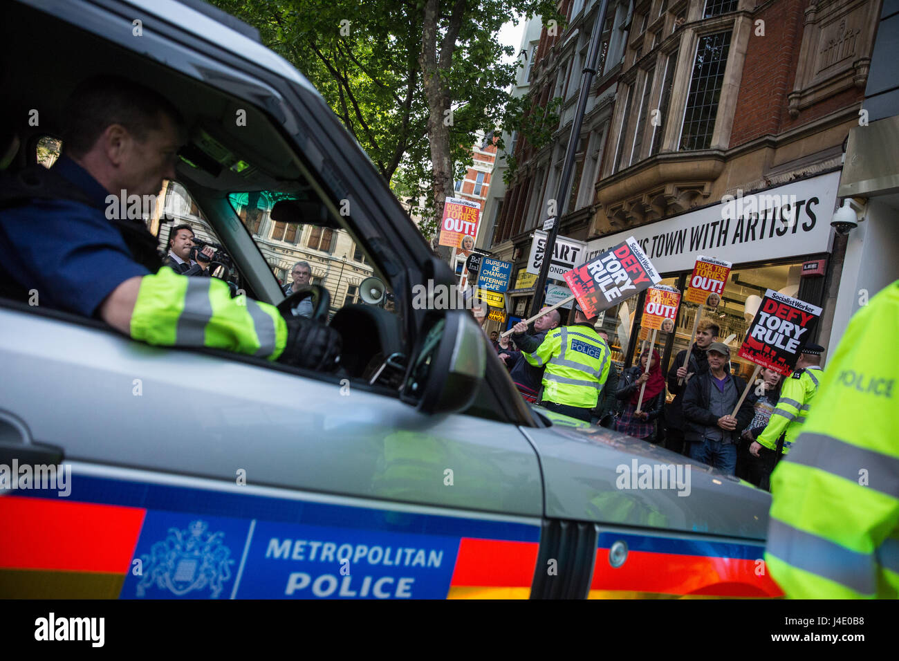 London, UK. 11th May, 2017. A small protest greets the arrival of Prime Minister Theresa May with a police escort for a radio phone-in at LBC. Credit: Mark Kerrison/Alamy Live News Stock Photo