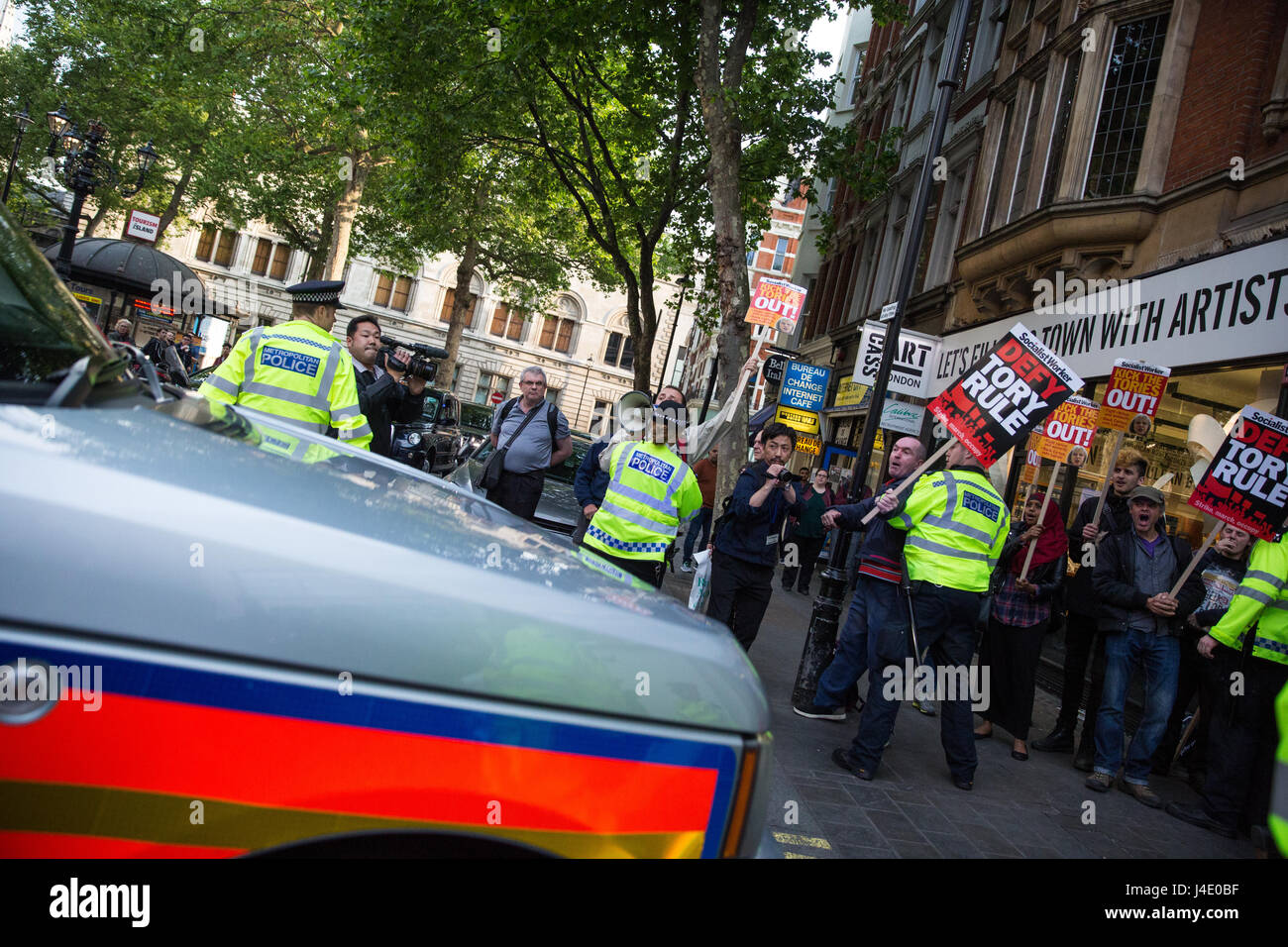 London, UK. 11th May, 2017. A small protest greets the arrival of Prime Minister Theresa May with a police escort for a radio phone-in at LBC. Credit: Mark Kerrison/Alamy Live News Stock Photo