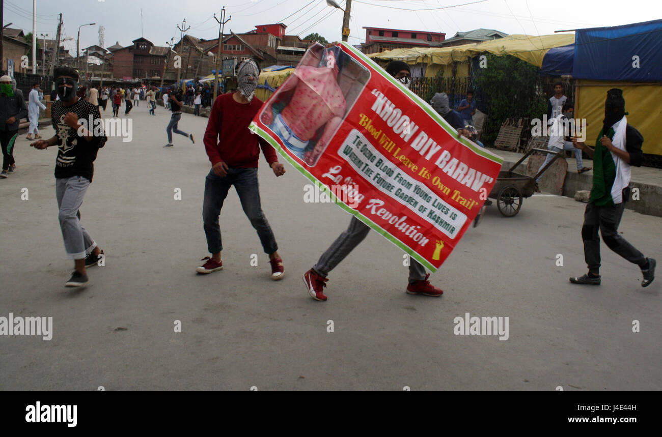 Srinagar, Kashmir. 12th May, 2017. .A Kashmiri protester holds banner of pellet victim. Clashes broke out between protesters and security forces in downtown Nowhatta area of Srinagar. Groups of youth indulged in sloganeering and stone- pelting at Indian security forces soon after Friday congregational prayers. According to the report, 102 unarmed civilians were killed in 135 days of unrest that was sparked by the killing on July 8 of Hizbul Mujahideen commander Burhan Wani by the armed forces. Credit: sofi suhail/Alamy Live News Stock Photo