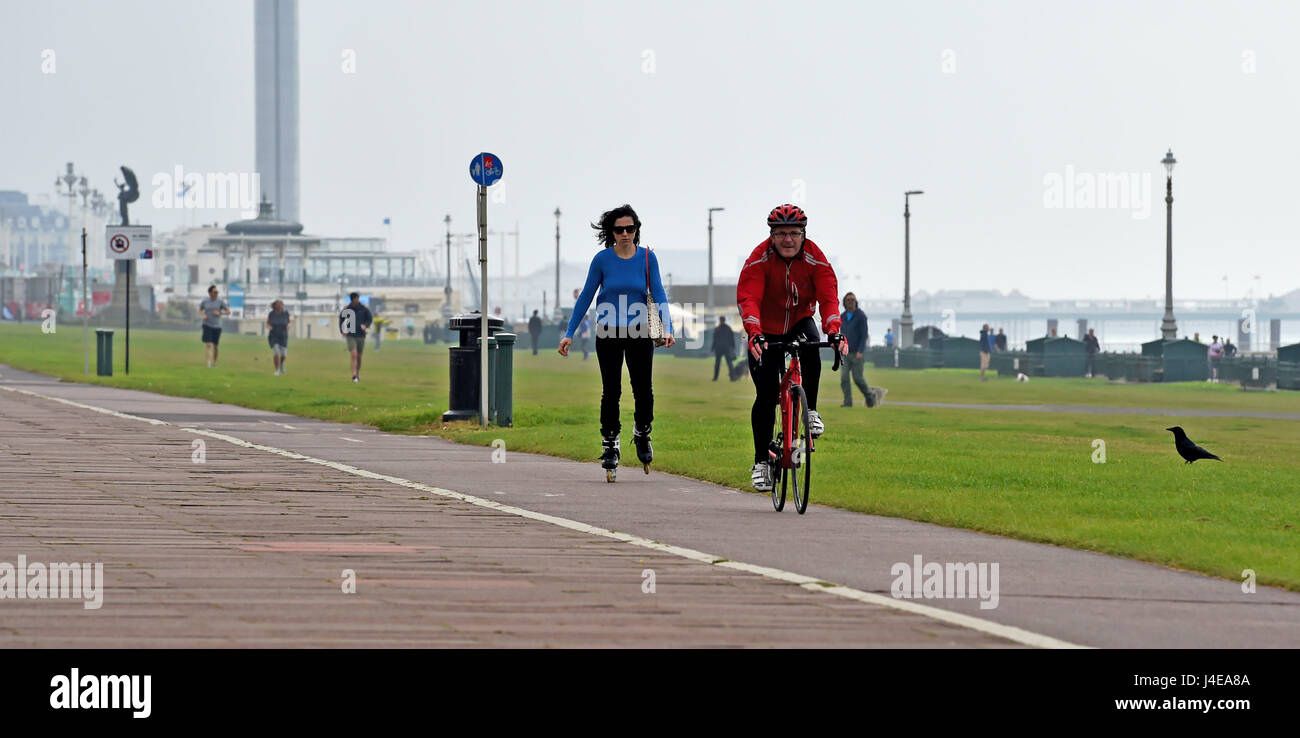 Brighton, UK. 13th May, 2017. Cyclists and roller bladers travel along Brighton and Hove seafront on a dull overcast morning . The forecast is for a mixture of sunshine and showers this weekend in the south with warnings of a water shortage due to a lack of rain this Spring Credit: Simon Dack/Alamy Live News Stock Photo