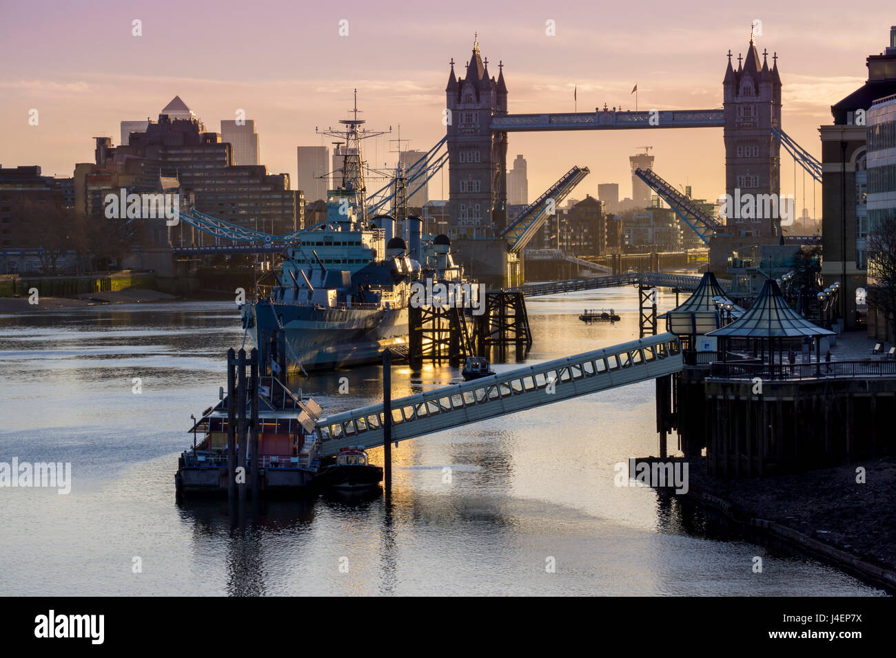 Tower Bridge raising deck with HMS Belfast on the River Thames, London, England, United Kingdom, Europe Stock Photo