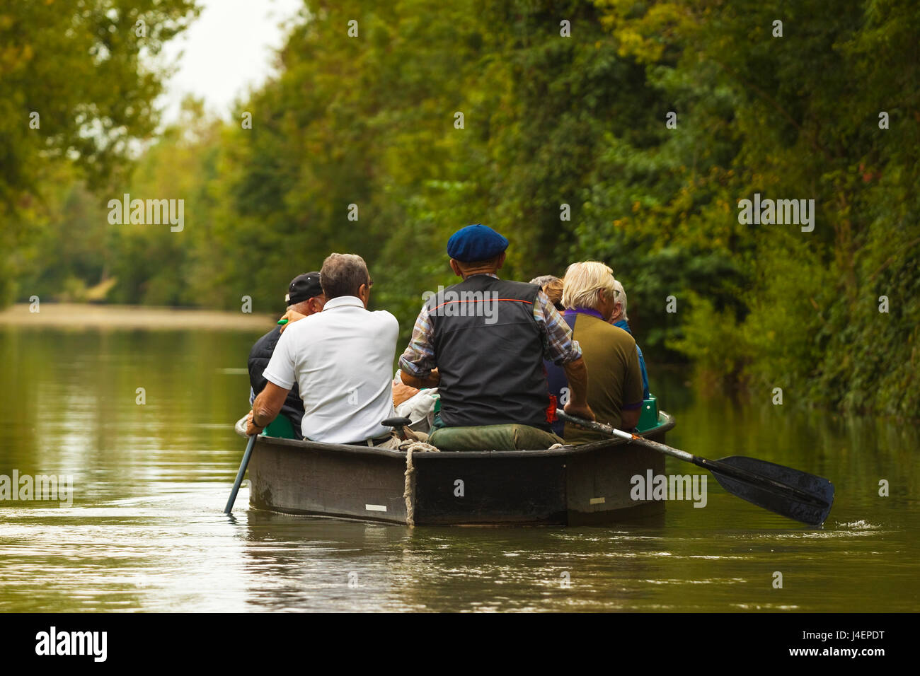 Tourists paddling boat in the Marais Poitevin (Green Venice) wetlands, Arcais, Nouvelle-Aquitaine, France, Europe Stock Photo