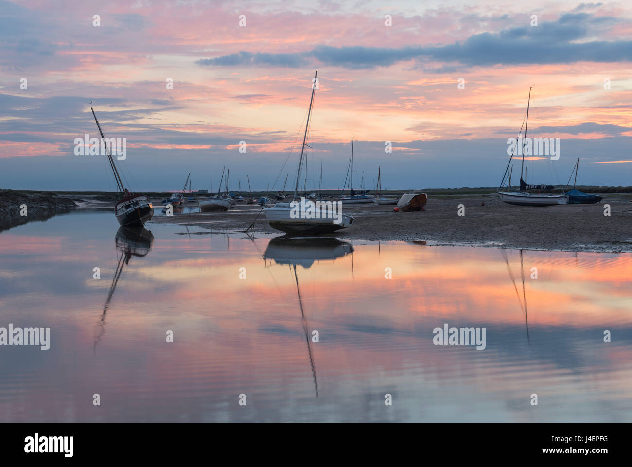 Sunset over the tidal channel at Brancaster Staithe, Norfolk, England, United Kingdom, Europe Stock Photo