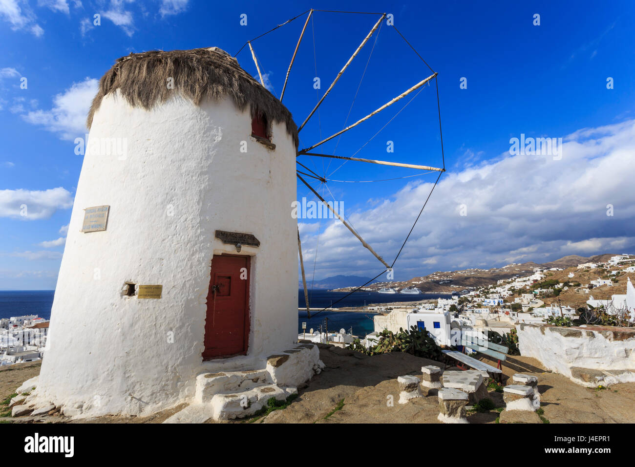 Whitewashed windmill, view of Mykonos Town (Chora) and cruise ships in distance, Mykonos, Cyclades, Greek Islands, Greece Stock Photo