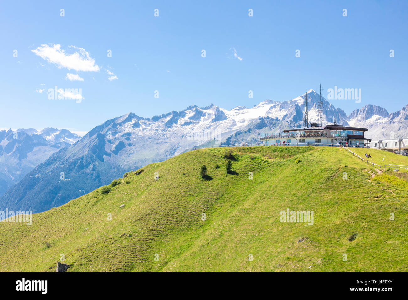 Green meadows and rocky peaks frame the Rifugio Doss Del Sabion, Pinzolo, Brenta Dolomites, Trentino-Alto Adige, Italy, Europe Stock Photo