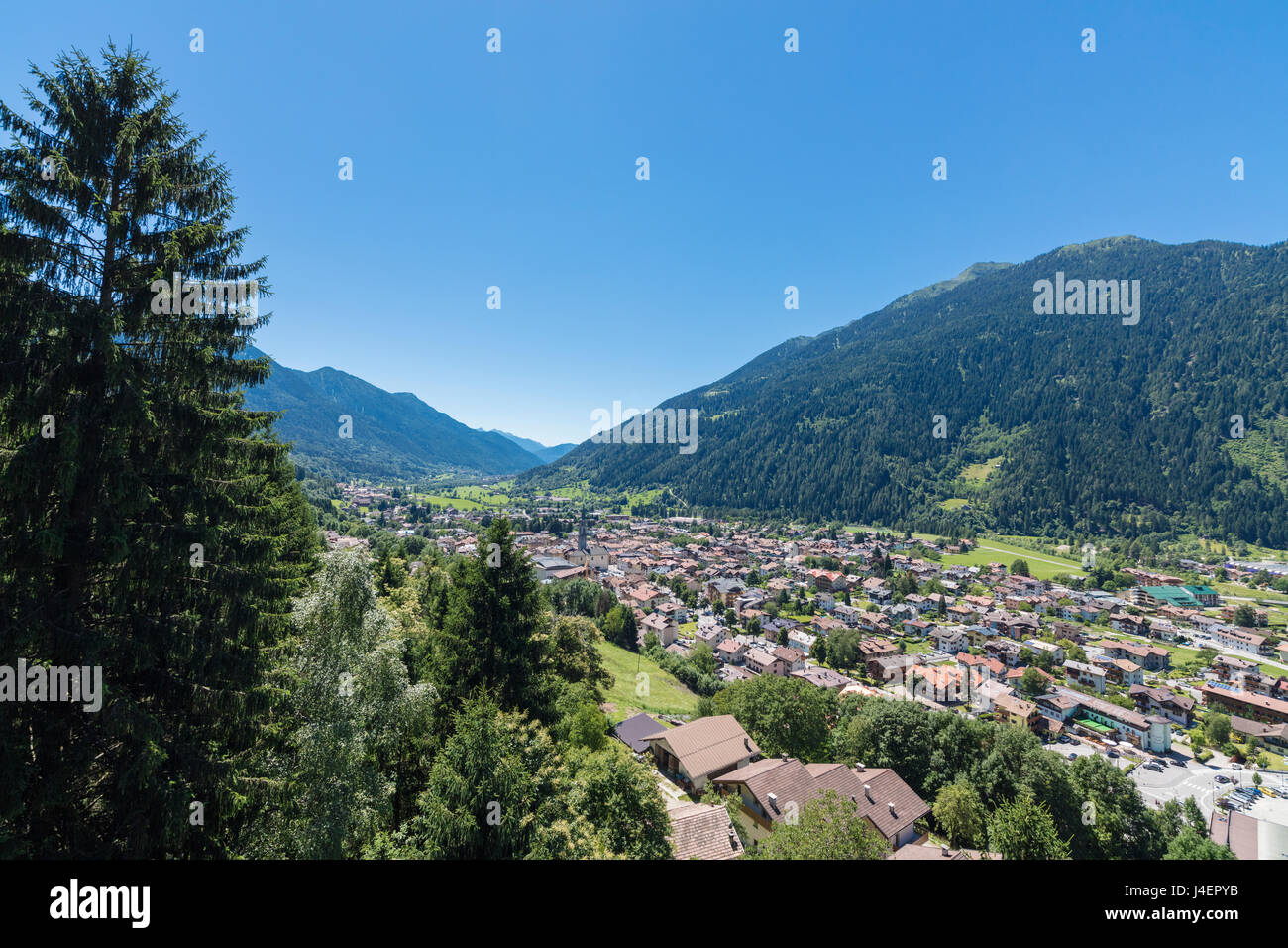 Blue sky and woods frame the alpine village of Pinzolo, Brenta Dolomites, Trentino-Alto Adige, Italy, Europe Stock Photo