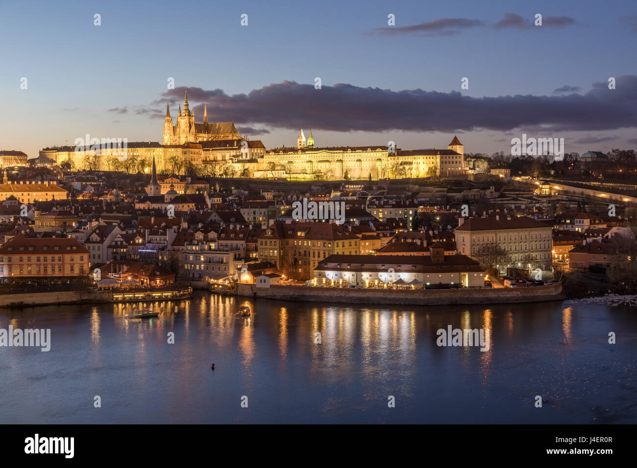 View of the Vltava River framed by historical buildings at dusk, Prague, Czech Republic, Europe Stock Photo