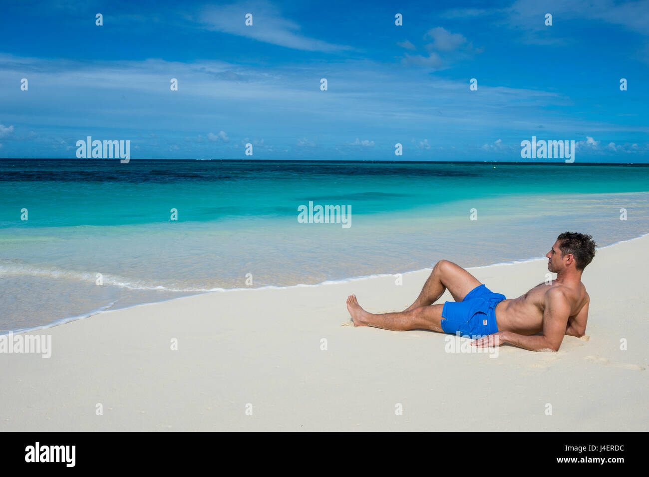 Man relaxing on the world class Shoal Bay East beach, Anguilla, British Oversea territory, West Indies, Caribbean Stock Photo