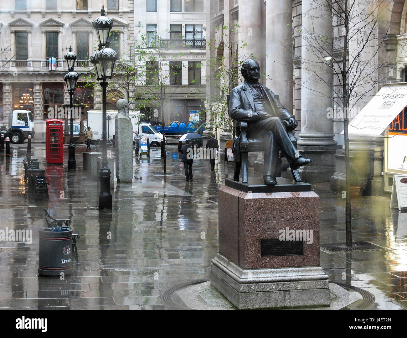 Statue of George Peabody, an American banker, outside the Royal Exchange in London taken in the rain. There is a copy in Baltimore Stock Photo
