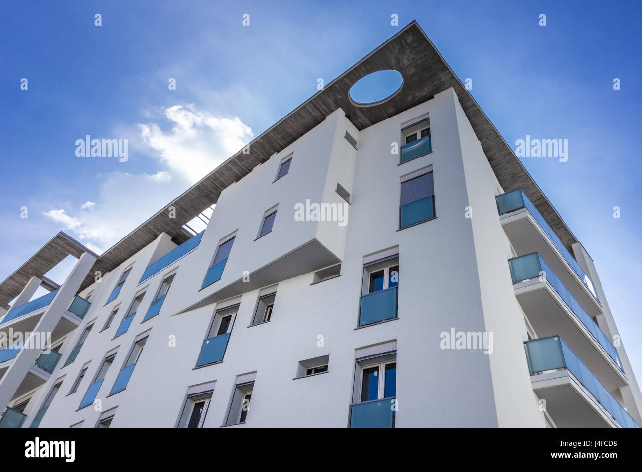 White living house with apartments with sky background Stock Photo - Alamy