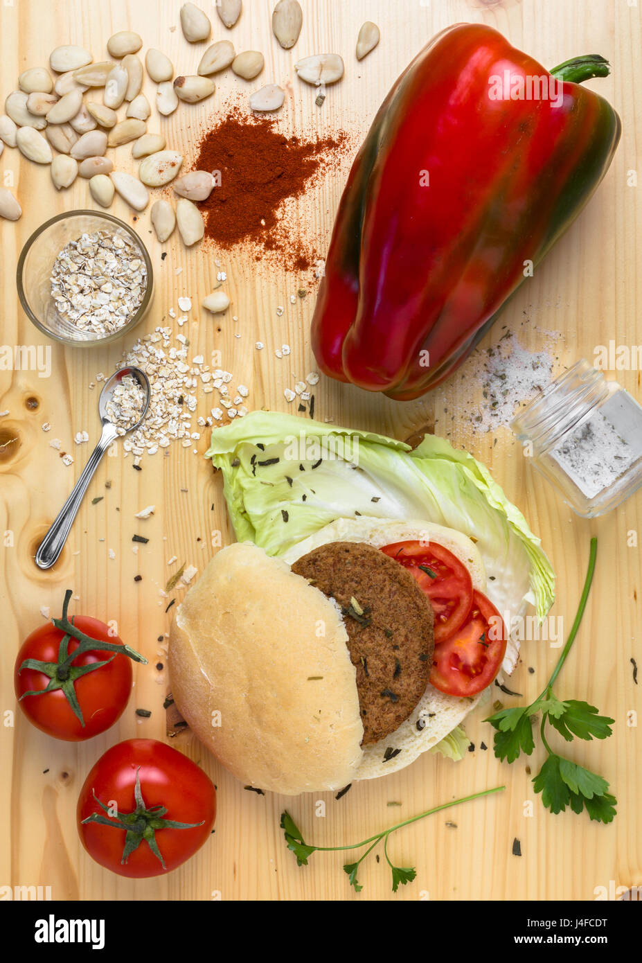 Homemade veg burger with ingredients, on a light wooden background. Top view. Stock Photo