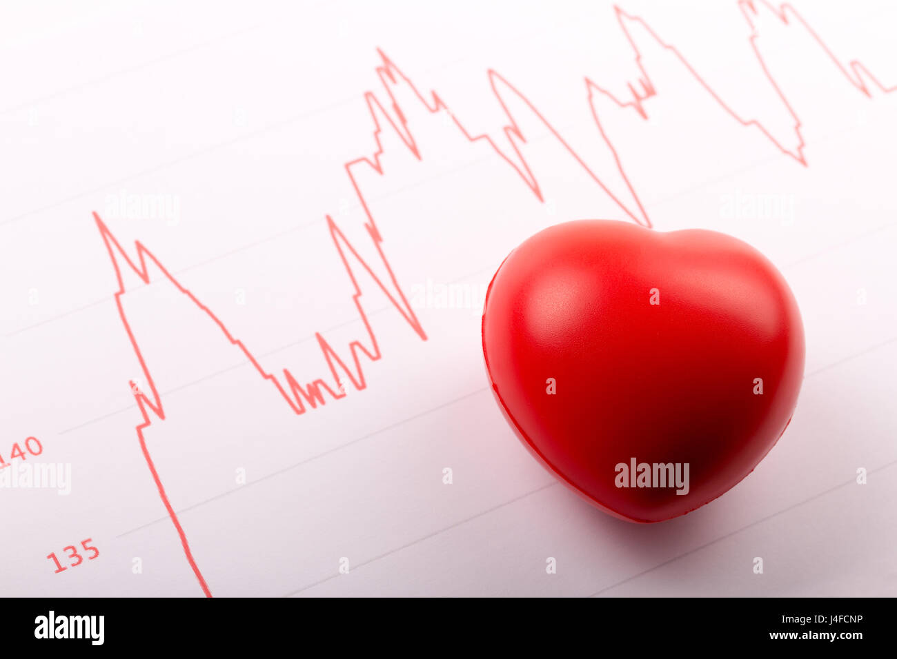 heart health - red rubber heart and cardiogram Stock Photo
