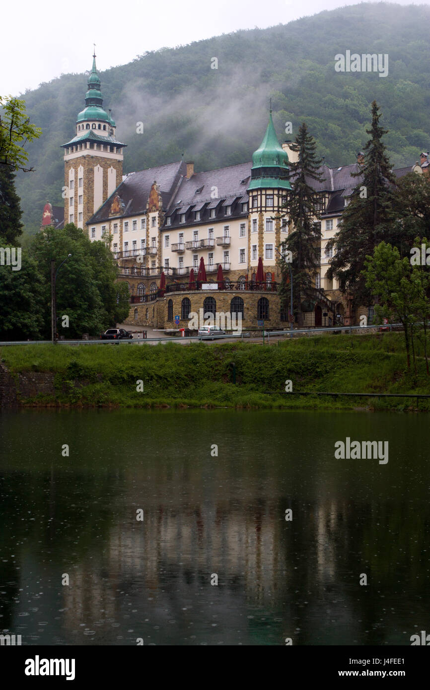 The Palace Hotel and Lake Hamori in the Bukk mountains at Lillafured, Miskolc, Hungary on a rainy day. Natural reflections on the water surface. Stock Photo