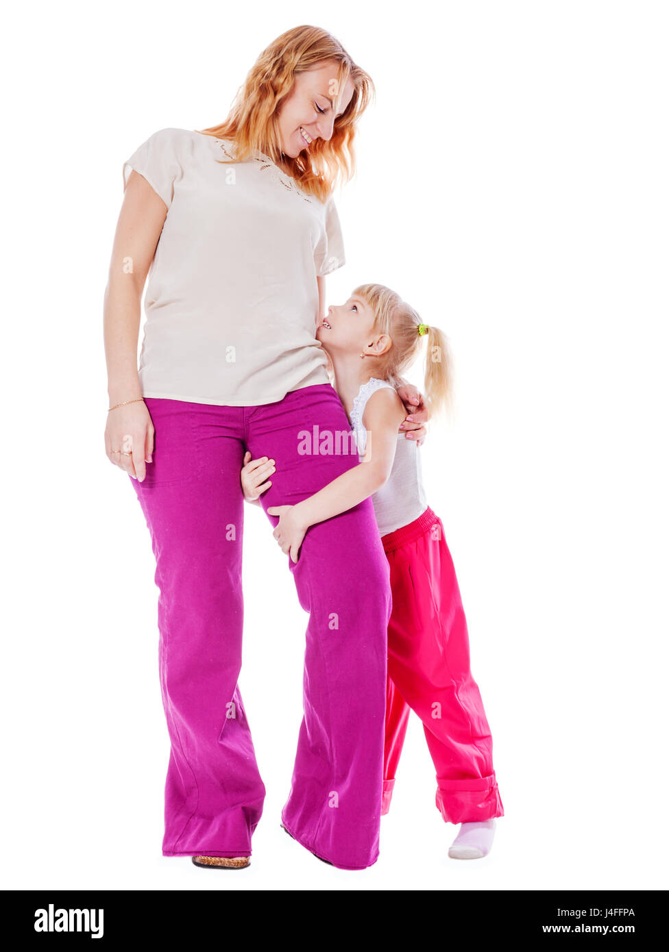Mother and daughter standing holding hands isolated Stock Photo - Alamy