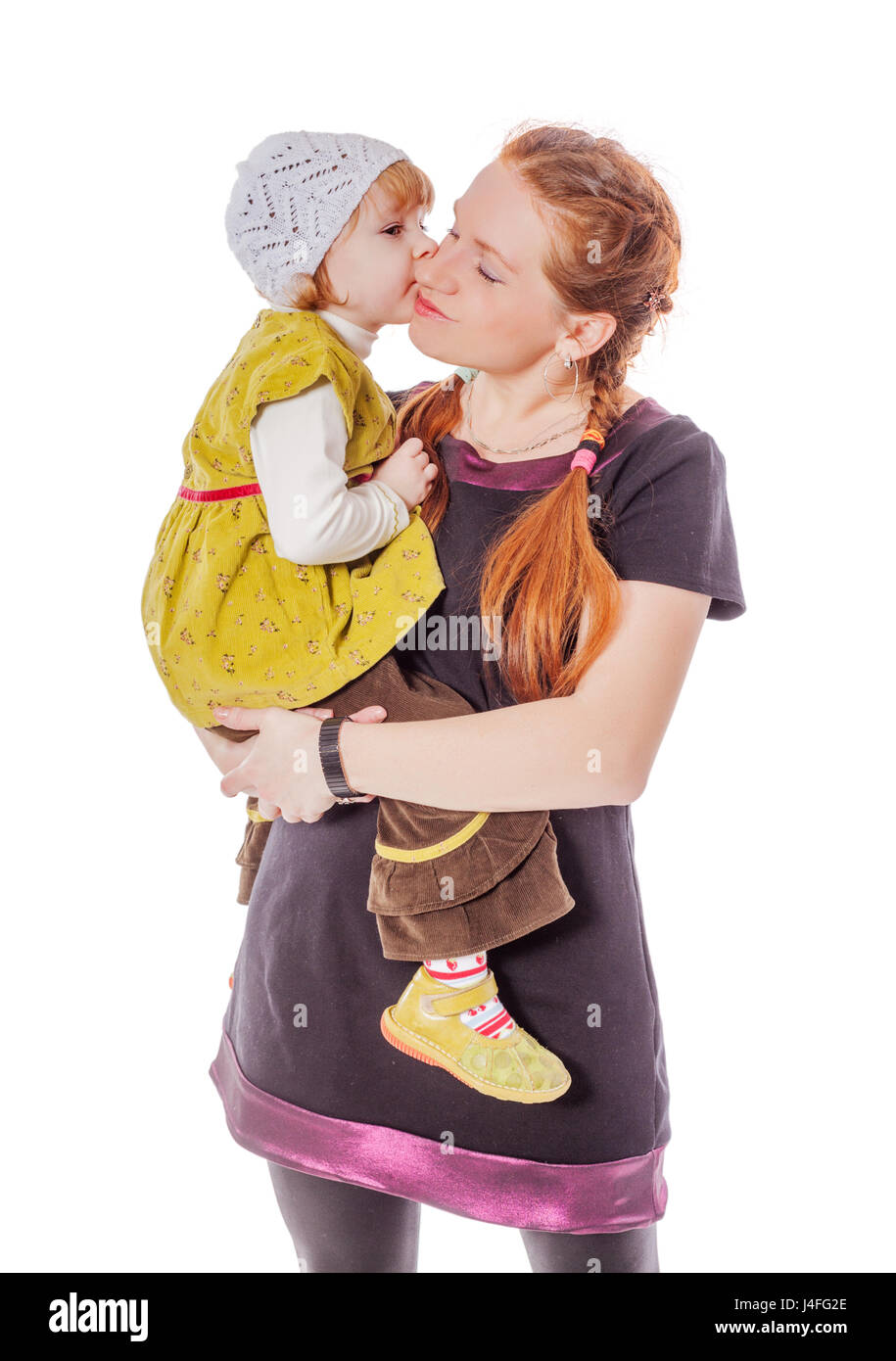 Two years daughter kissing mother isolated on white Stock Photo